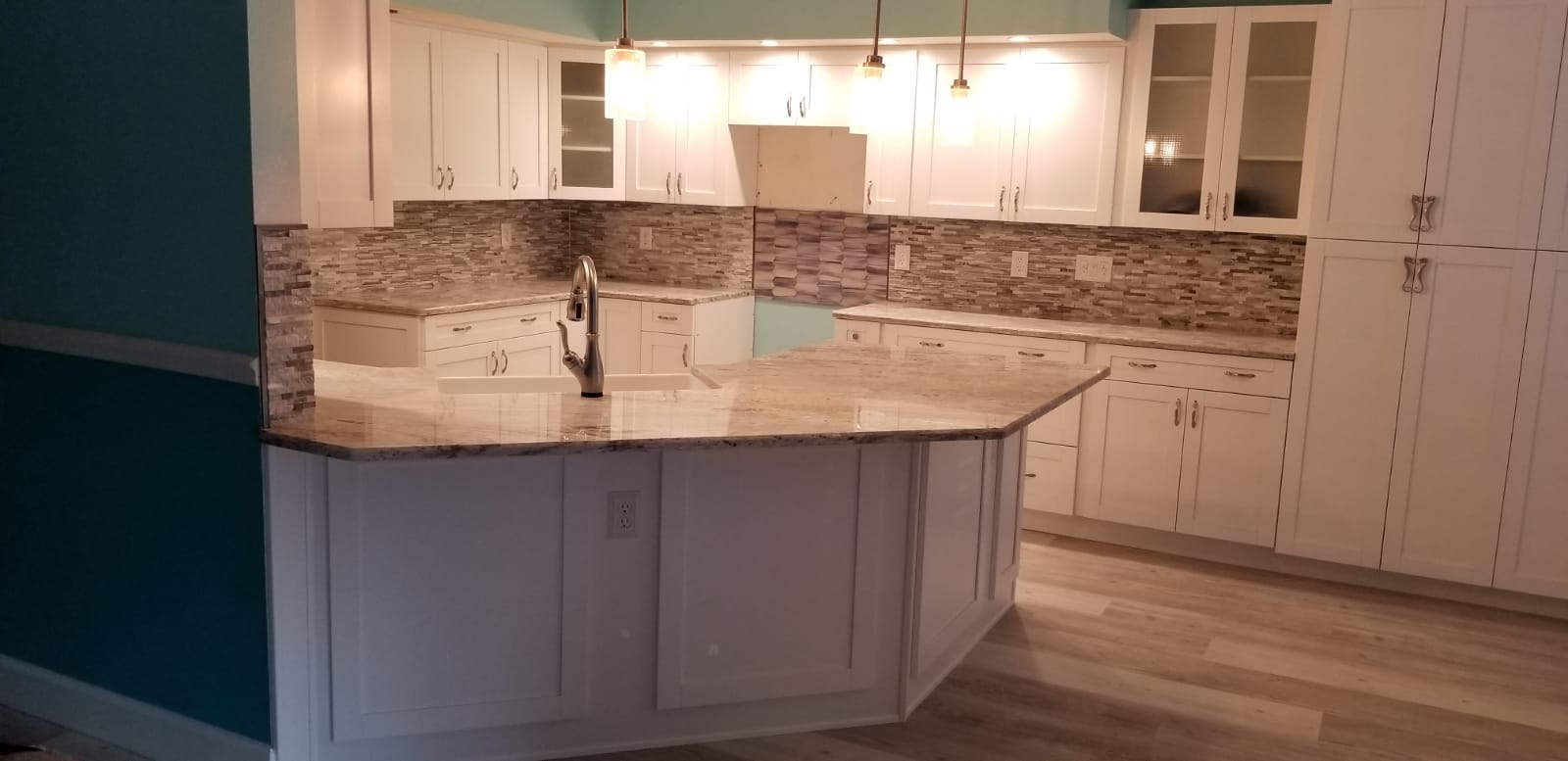 Modern kitchen with white cabinetry and marble countertops