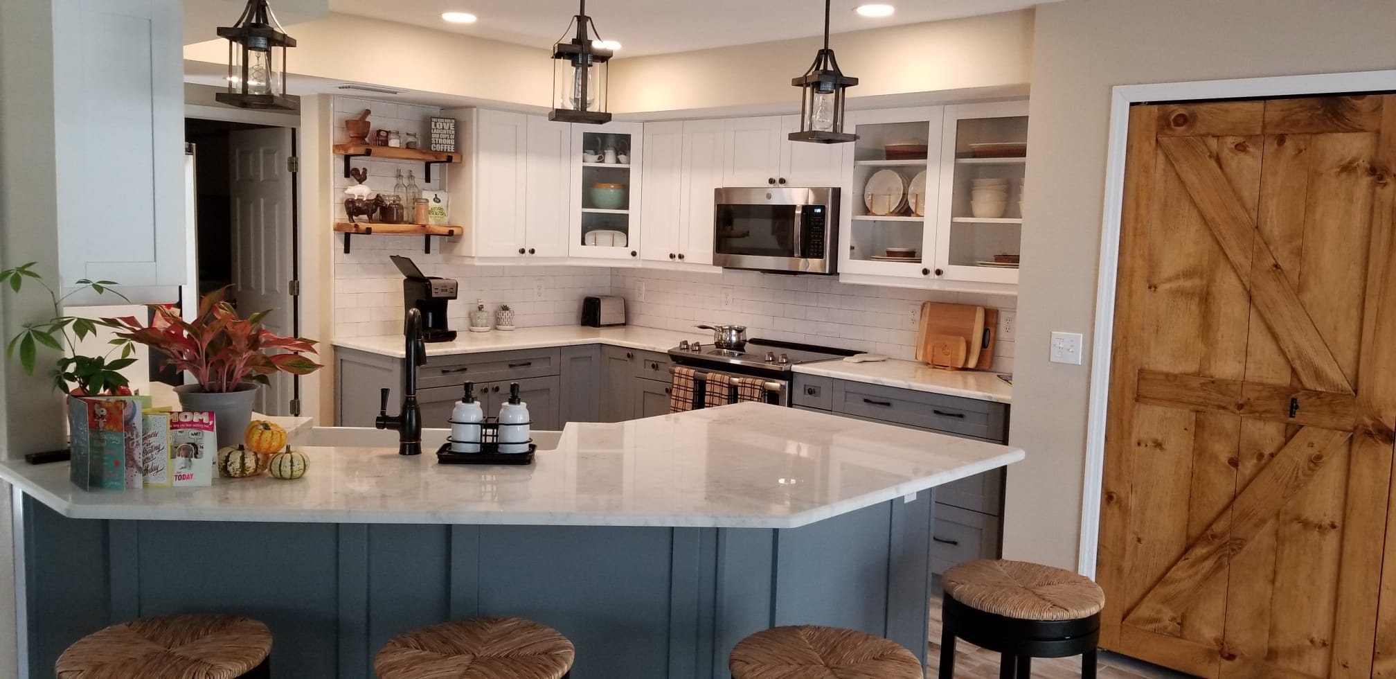 Modern kitchen with white cabinets and a large island with stools